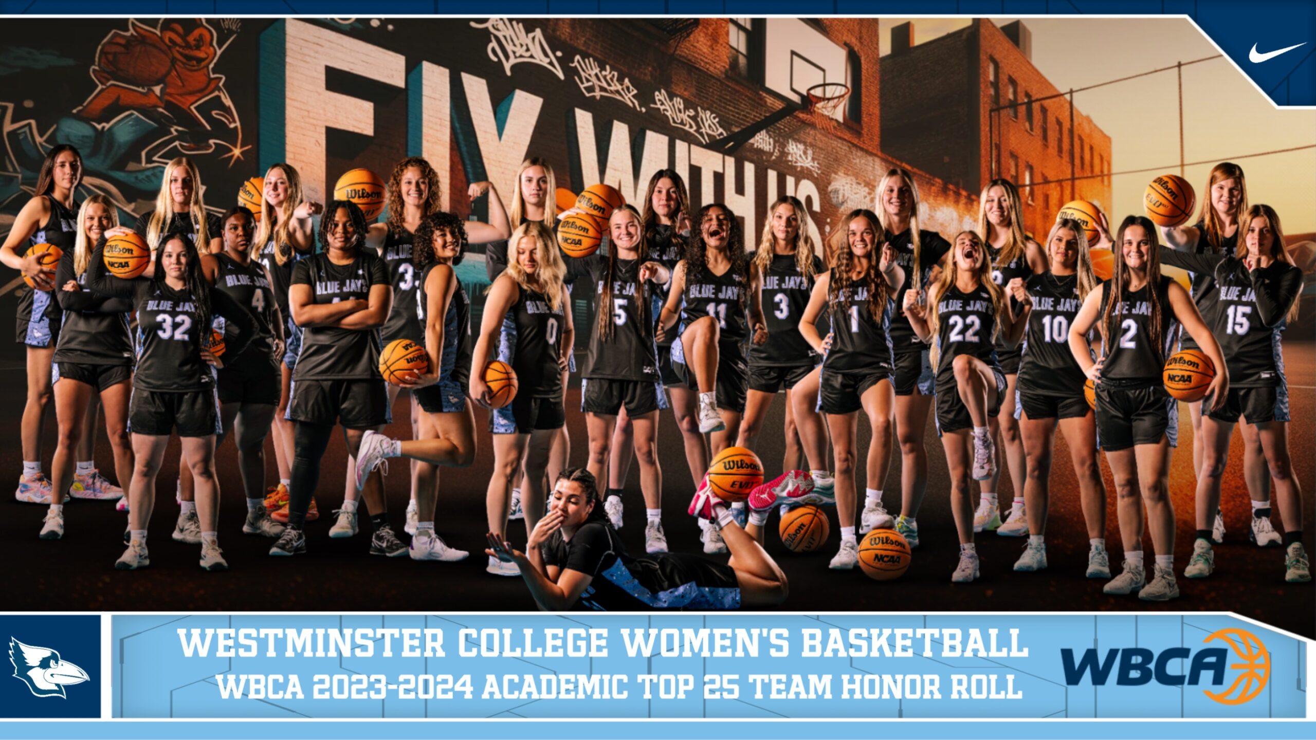 The women's basketball team poses for a photo.