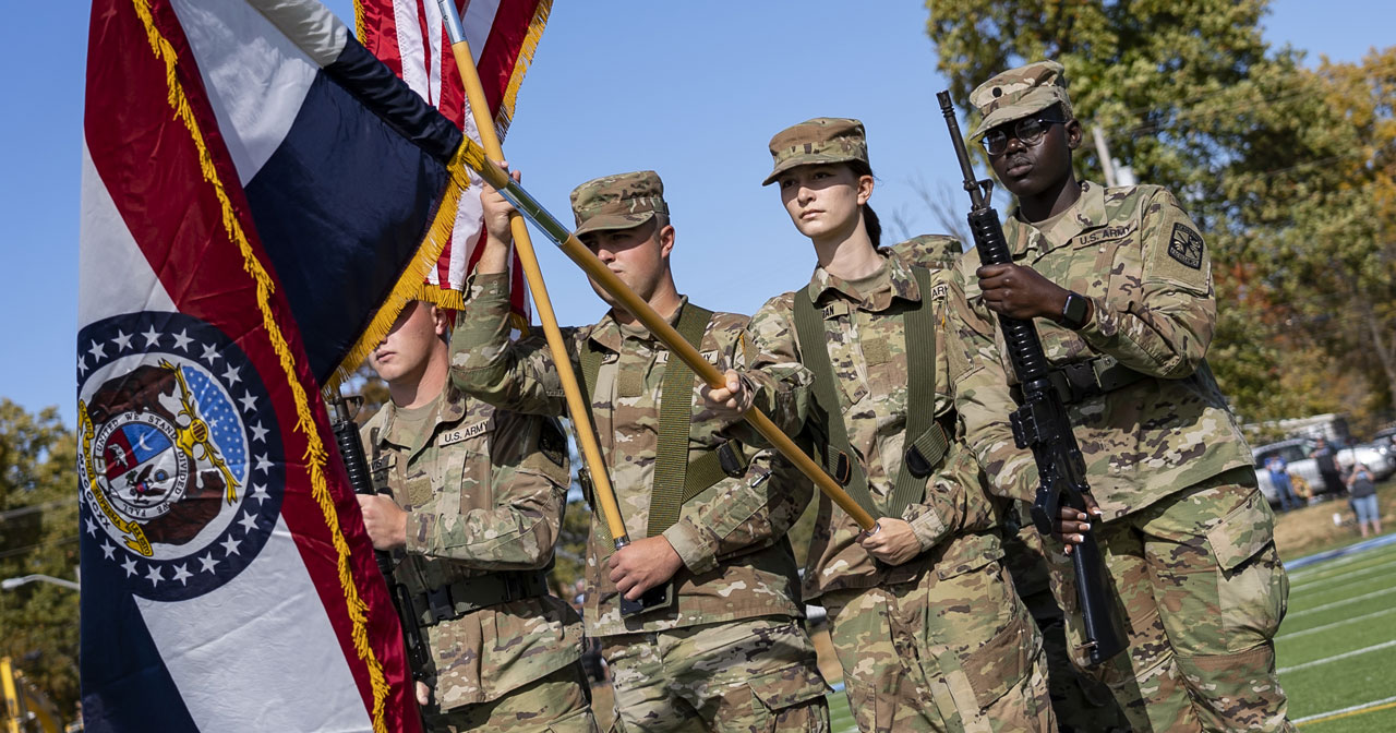 Four ROTC members post the colors during a Color Guard ceremony at Westminster's Blue Jay Field.