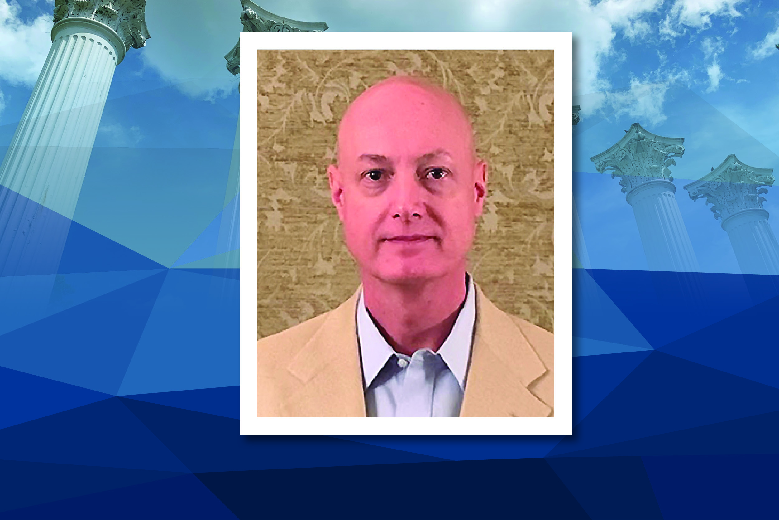 George Mahn III is pictured wearing a tan blazer and white shirt, his photo in a square box that is placed over a blue background.