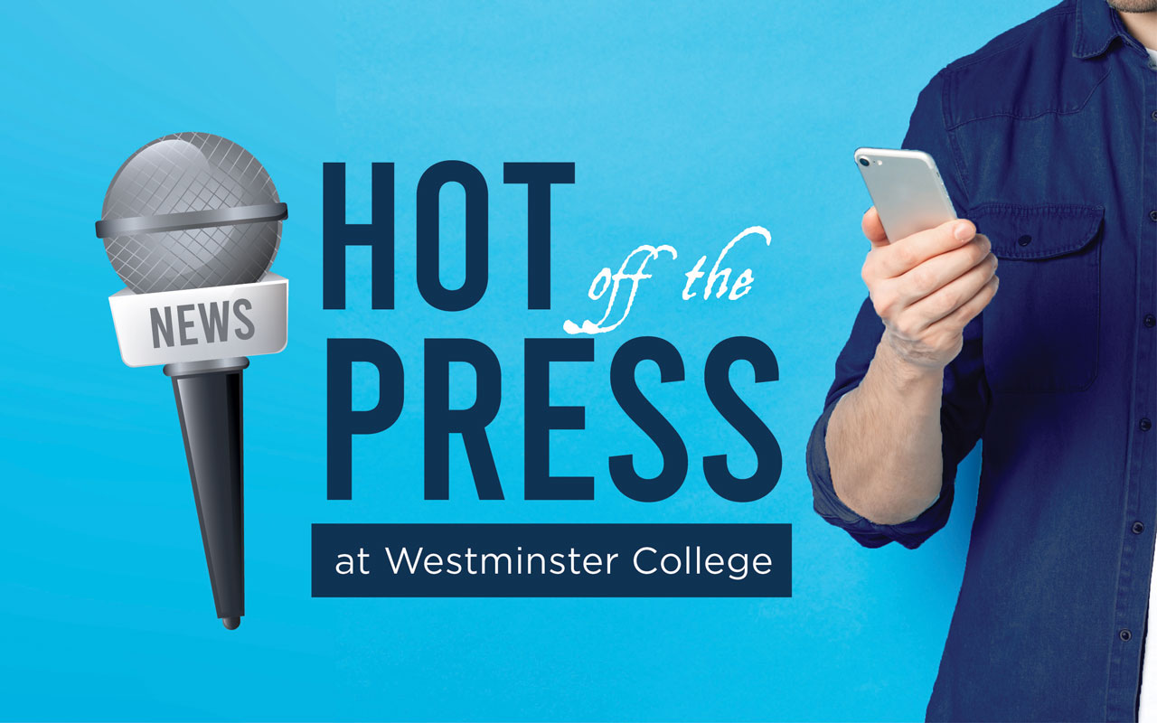 An unidentified person holds a phone with "Hot off the Press" featured next to the image. The text and image appear over a blue background, with a microphone placed to the far left.