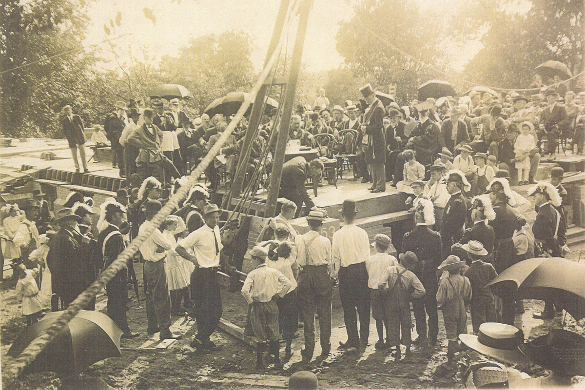 A sepia-toned photo shows people from standing on the original foundation of Westminster Hall on July 4, 1853, as the cornerstone is set.