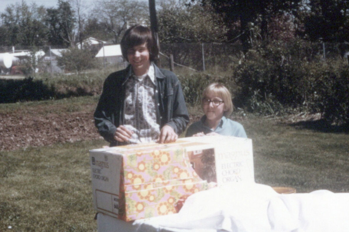 Bob Wise is pictured on the right of the picture as a child. On the left is the Big Brother from Westminster mentioned in the story. A gift is pictured in front of them. The are outside.
